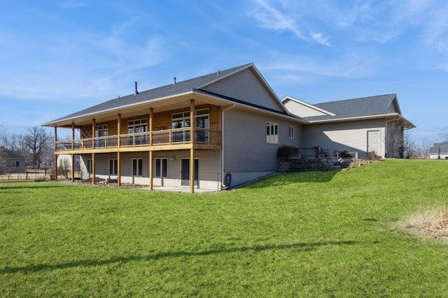 back of property featuring a lawn and a deck