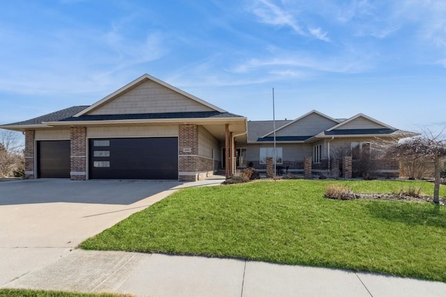 view of front of home featuring brick siding, a shingled roof, a front yard, a garage, and driveway