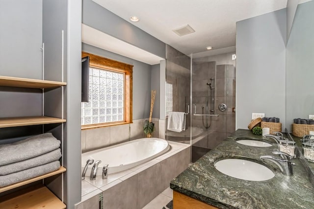 bathroom featuring a sink, visible vents, a stall shower, and a bath