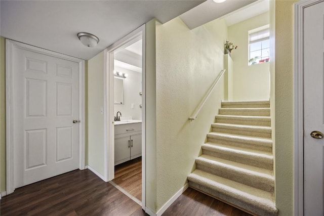 staircase with wood finished floors and baseboards