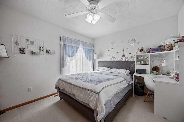 bedroom featuring light colored carpet, a textured ceiling, baseboards, and ceiling fan