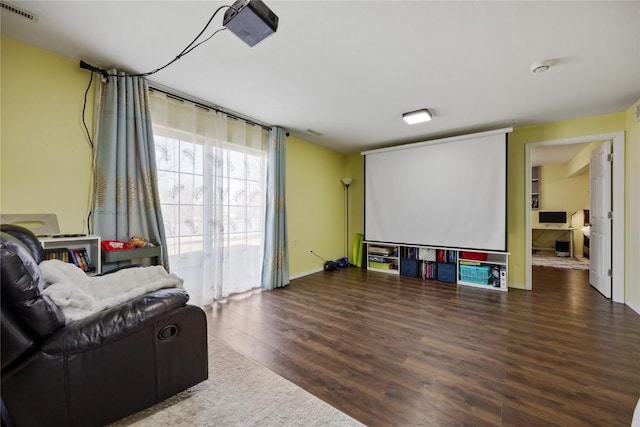 home theater room featuring wood finished floors and visible vents