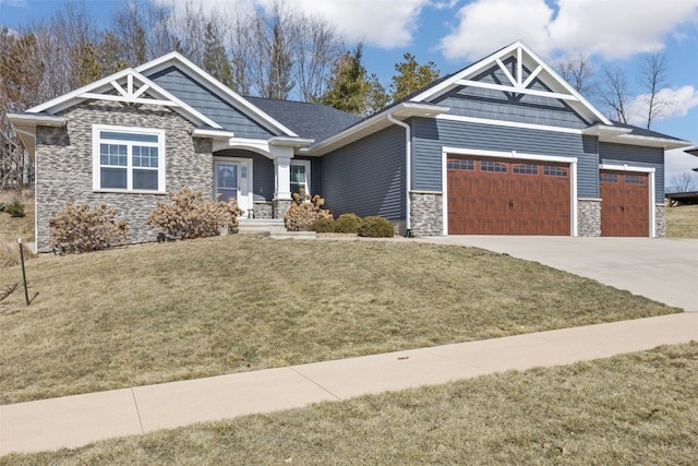 craftsman-style home with a front lawn, an attached garage, stone siding, and driveway