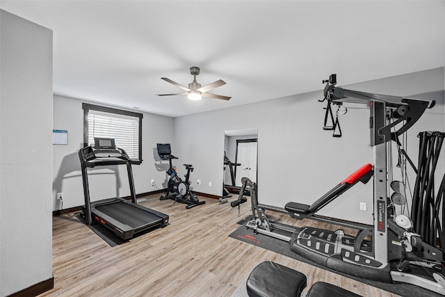 exercise room with wood finished floors, baseboards, and ceiling fan