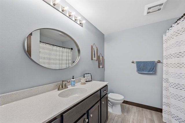 full bath with visible vents, baseboards, toilet, wood finished floors, and vanity