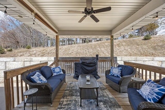 wooden terrace featuring a grill, an outdoor hangout area, and ceiling fan