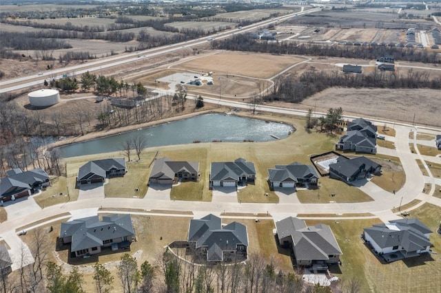 bird's eye view with a residential view and a water view