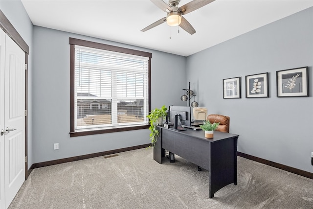 office featuring visible vents, baseboards, ceiling fan, and carpet floors