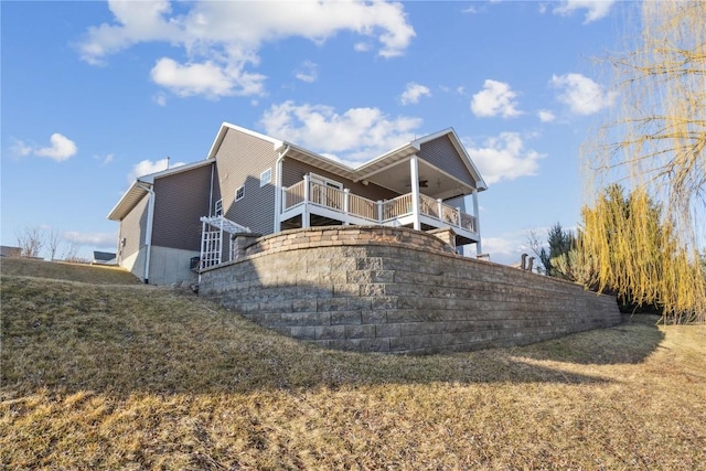 view of side of property with ceiling fan and stairs