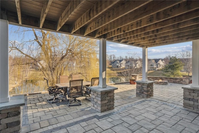 view of patio featuring a residential view, outdoor dining space, and an outdoor fire pit