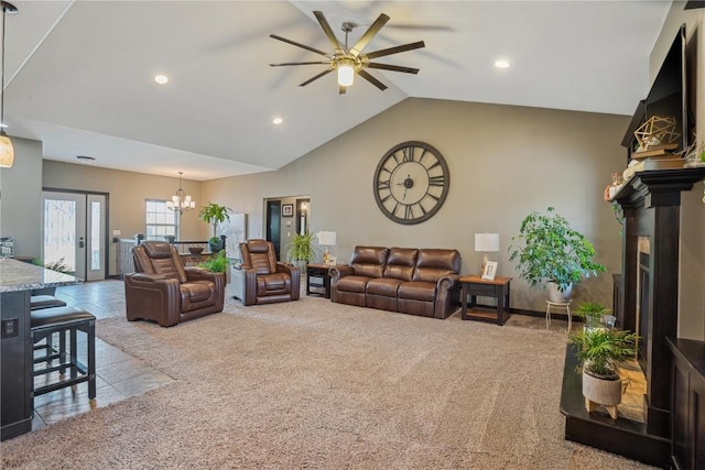 living area featuring vaulted ceiling, carpet flooring, ceiling fan with notable chandelier, and recessed lighting