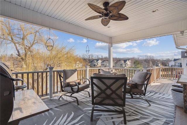 wooden terrace with a residential view and ceiling fan