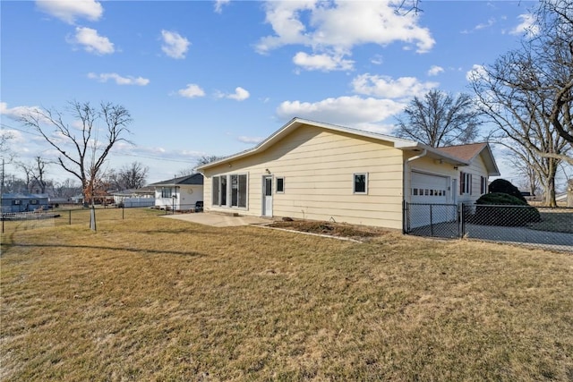 view of home's exterior with a patio, a garage, a lawn, and fence