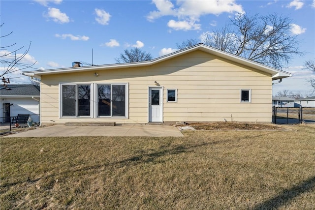 rear view of property with a gate, fence, a lawn, and a patio area