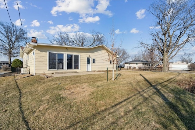 exterior space with ac unit, a patio, fence, a yard, and a chimney