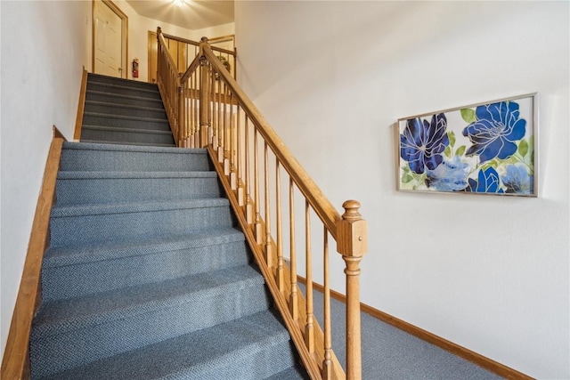 staircase with carpet and baseboards