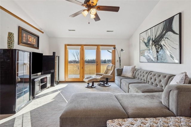 living area with visible vents, carpet floors, a ceiling fan, and vaulted ceiling