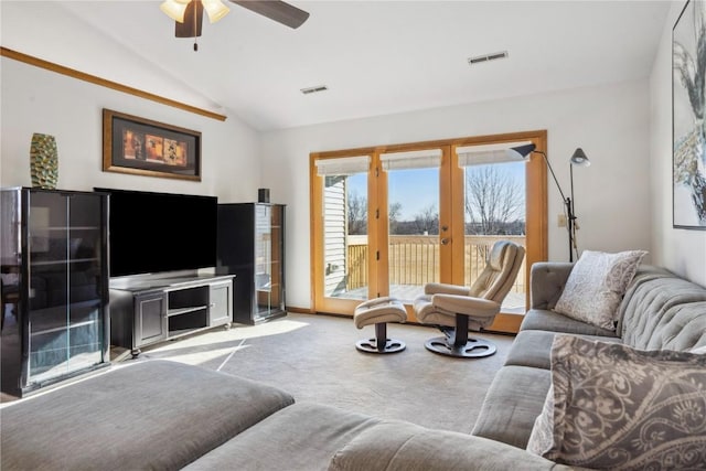 carpeted living area featuring vaulted ceiling, french doors, visible vents, and ceiling fan