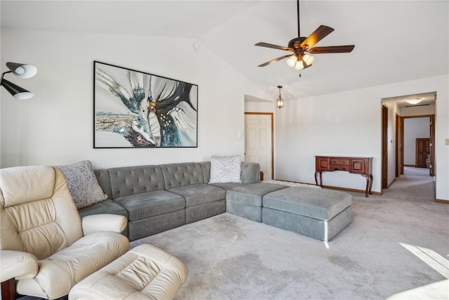 living room featuring carpet flooring, baseboards, a ceiling fan, and vaulted ceiling