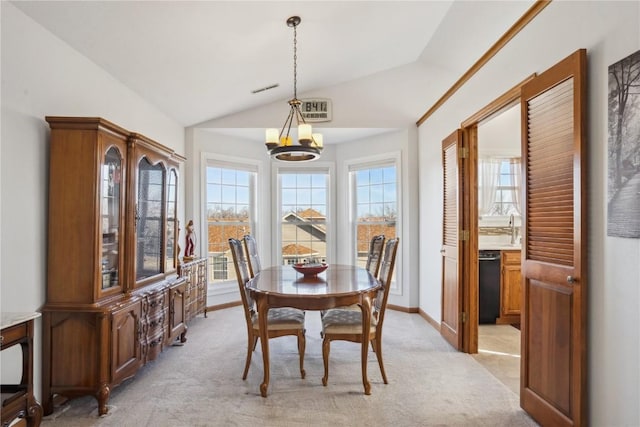 dining space featuring visible vents, baseboards, light colored carpet, a chandelier, and vaulted ceiling