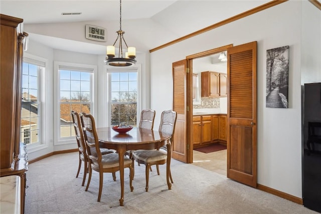 dining room with visible vents, lofted ceiling, an inviting chandelier, baseboards, and light colored carpet