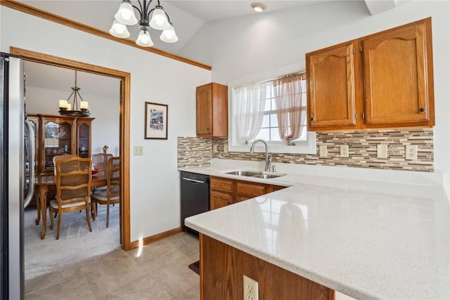 kitchen with a sink, black dishwasher, freestanding refrigerator, an inviting chandelier, and brown cabinetry