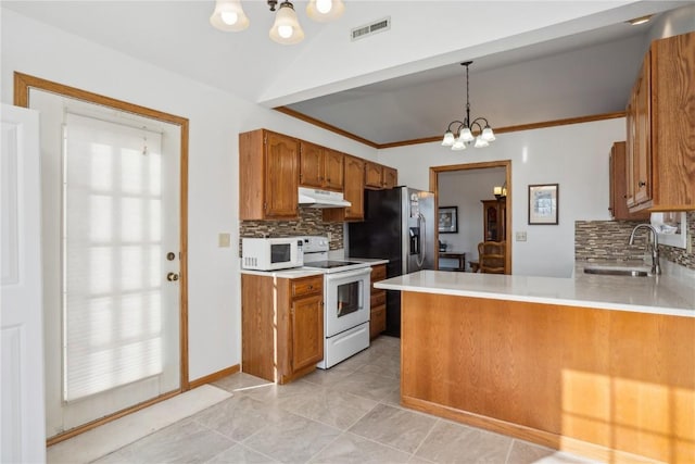 kitchen featuring under cabinet range hood, visible vents, white appliances, and an inviting chandelier