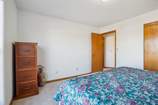 bedroom featuring baseboards and light carpet