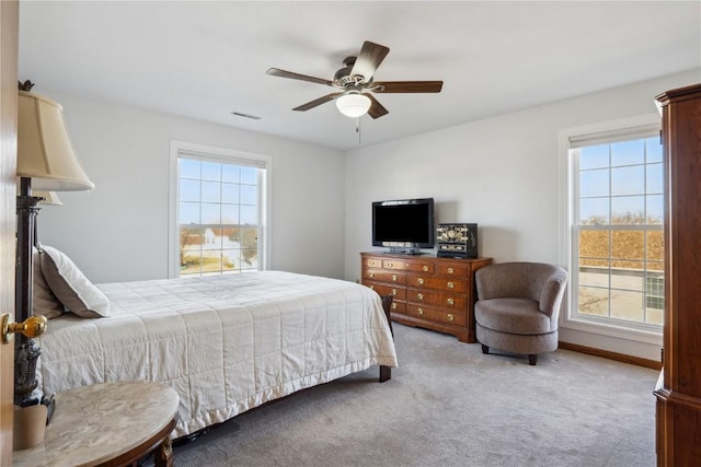 bedroom with baseboards, carpet, visible vents, and ceiling fan