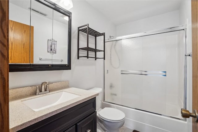 full bath featuring visible vents, toilet, vanity, and bath / shower combo with glass door