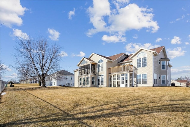 rear view of house featuring a lawn