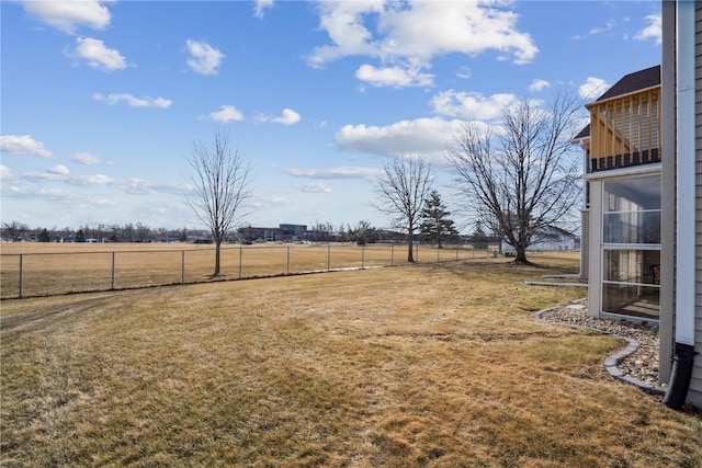 view of yard with a rural view and fence