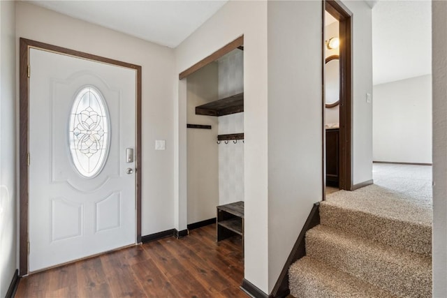 foyer with baseboards and dark wood-type flooring