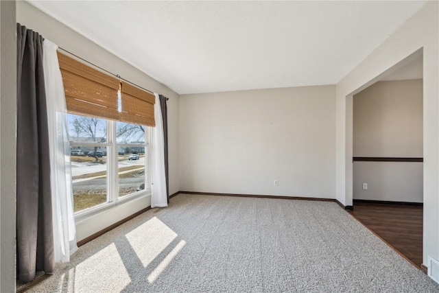 unfurnished room featuring baseboards