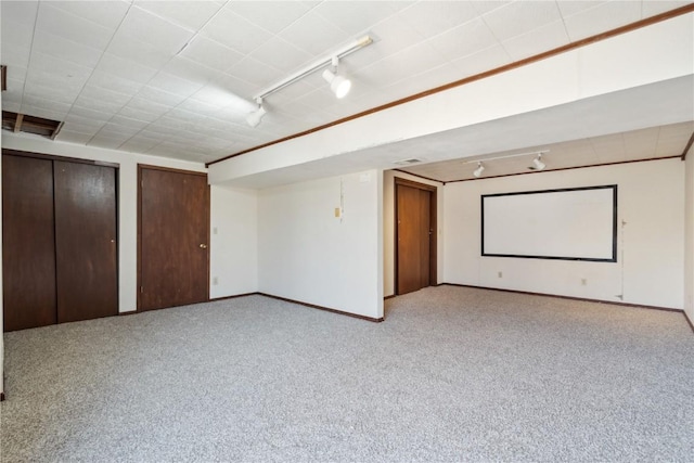 home theater room featuring visible vents, rail lighting, baseboards, and carpet floors