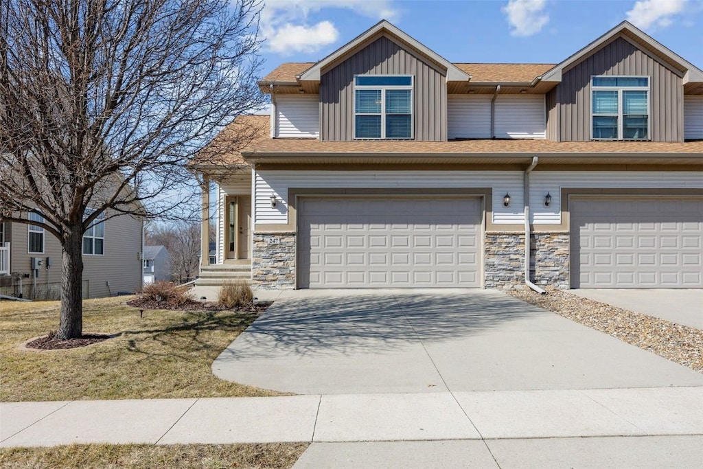 view of front of house featuring board and batten siding, concrete driveway, and an attached garage