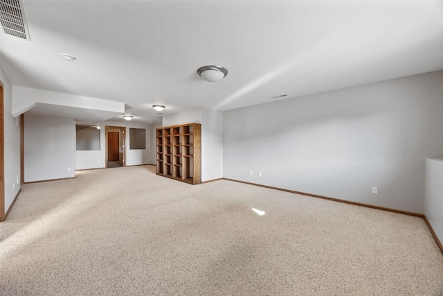 empty room with light colored carpet, baseboards, and visible vents