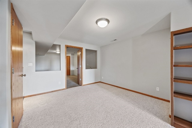 unfurnished bedroom featuring carpet flooring, visible vents, and baseboards