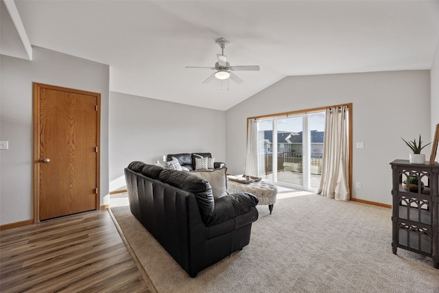 living area featuring lofted ceiling, wood finished floors, a ceiling fan, and baseboards