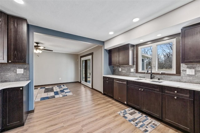2261 Creekside Rd, Springville, IA 52336 - kitchen featuring dishwasher, a sink, dark brown cabinetry, tasteful backsplash, and recessed lighting