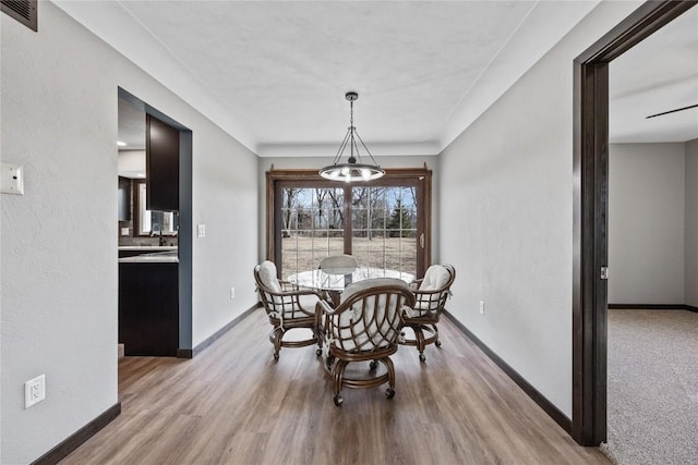 2261 Creekside Rd, Springville, IA 52336 - dining area with baseboards and light wood-type flooring