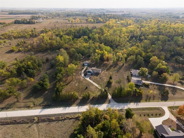 birds eye view of property with a wooded view