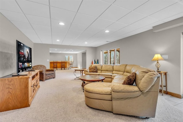 living area featuring recessed lighting, baseboards, a paneled ceiling, and light colored carpet