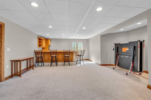 bar with bar area, recessed lighting, a paneled ceiling, baseboards, and light colored carpet