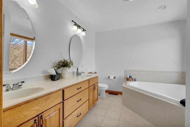 bathroom with a garden tub, toilet, a sink, tile patterned flooring, and double vanity