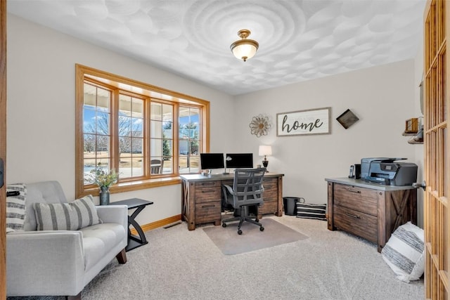 office featuring light carpet, visible vents, and baseboards