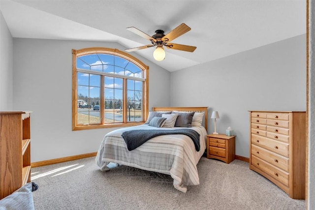 bedroom with light carpet, a ceiling fan, baseboards, and vaulted ceiling