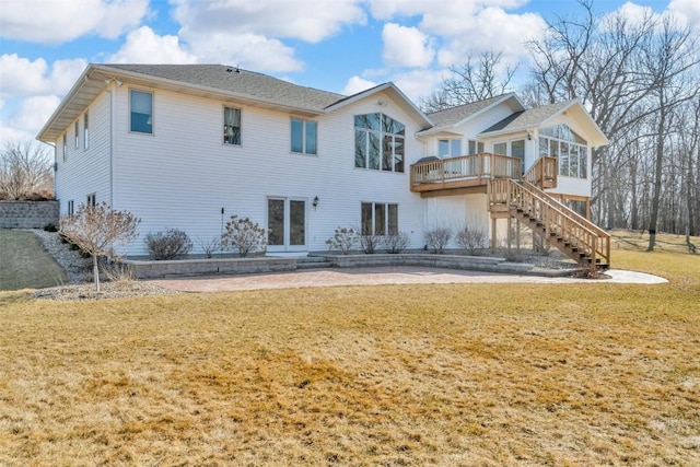 rear view of property with stairway, a lawn, and a deck