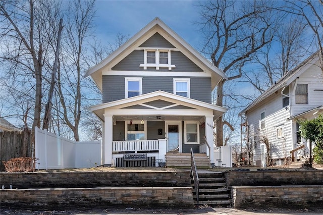 traditional style home with a porch and fence