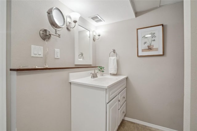 bathroom featuring visible vents, baseboards, and vanity